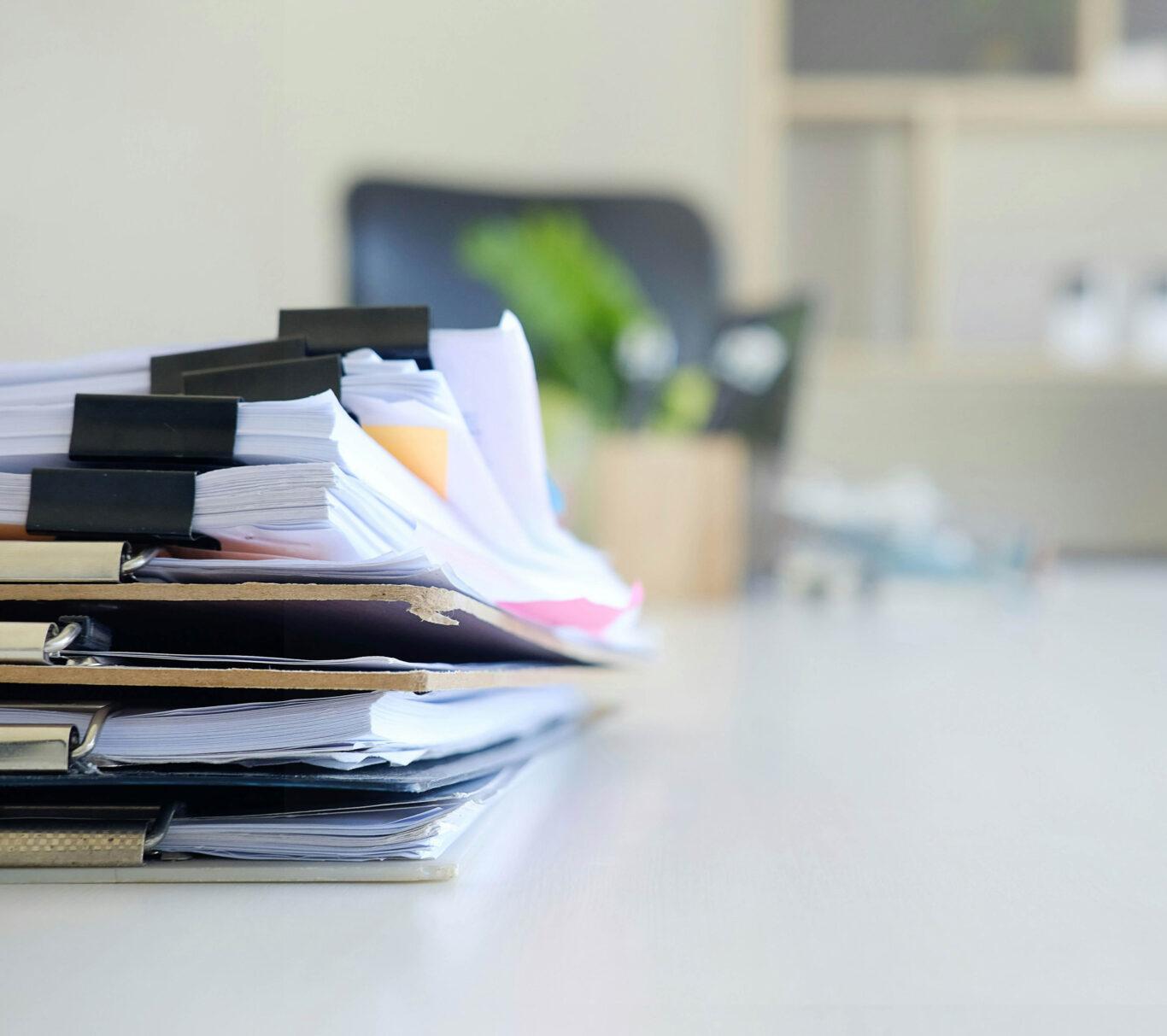 a stack of paperwork on a desk