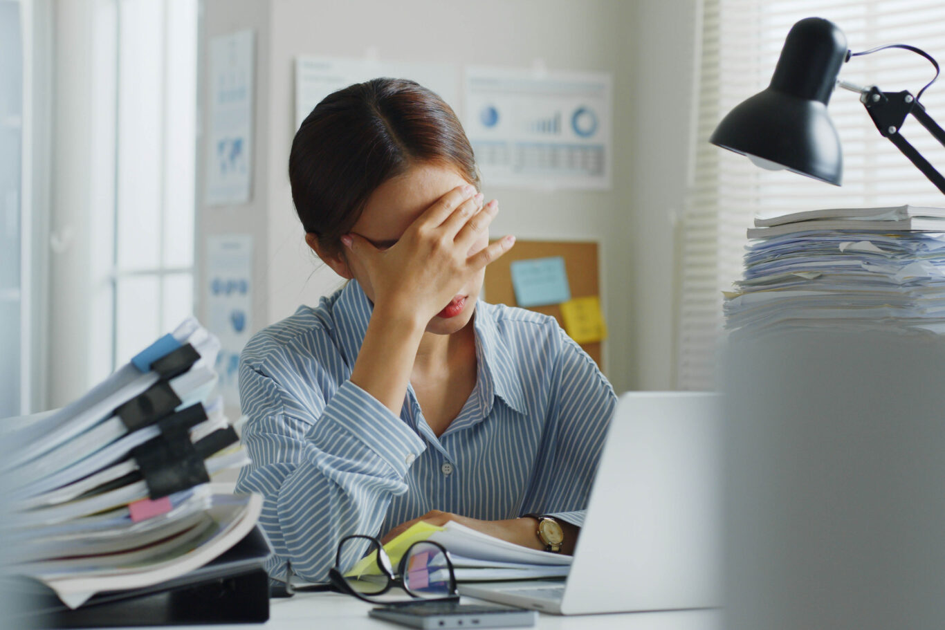 a woman appearing stressed while working on a computer