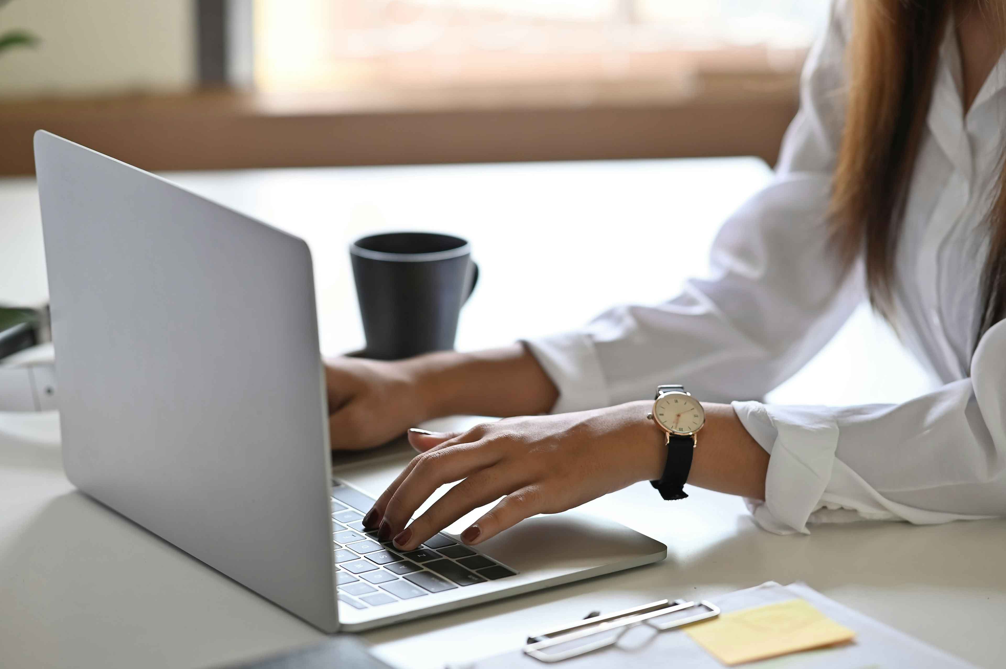 close up of paralegal hands working on a laptop